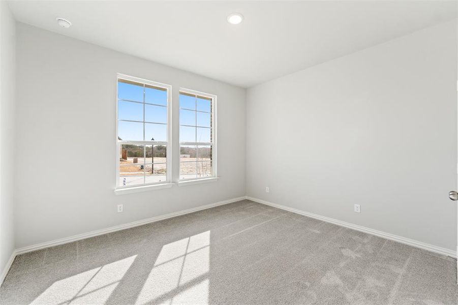 Unfurnished room with light colored carpet and recessed lighting
