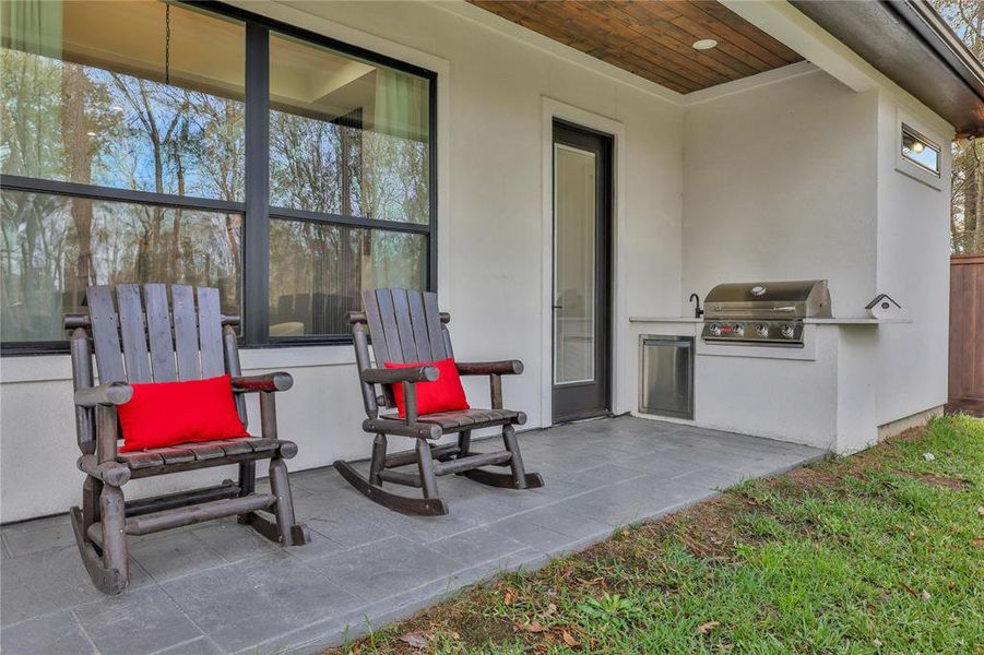 Outdoor kitchen with sink for grillin and chillin! That door leads into secondary bedroom.