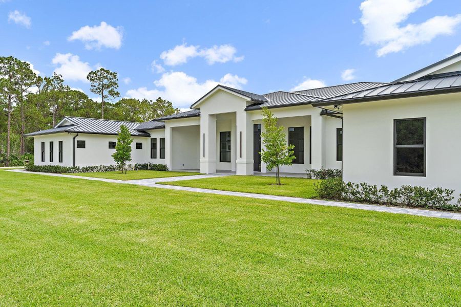 Front exterior of a new home in , Jupiter, FL, highlighting curb appeal (Image 2).