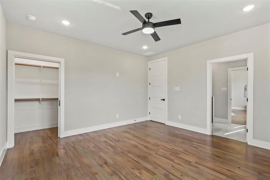Unfurnished bedroom with wood finished floors, a closet, a ceiling fan, and recessed lighting Unfurnished bedroom with wood finished floors, a closet, a ceiling fan, and recessed lighting