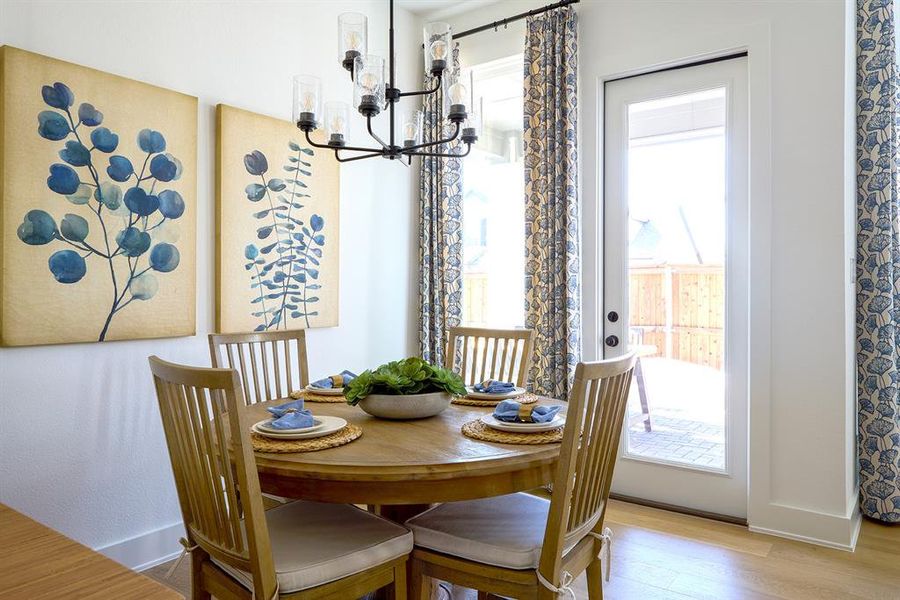 Dining space featuring a chandelier and wood finished floors