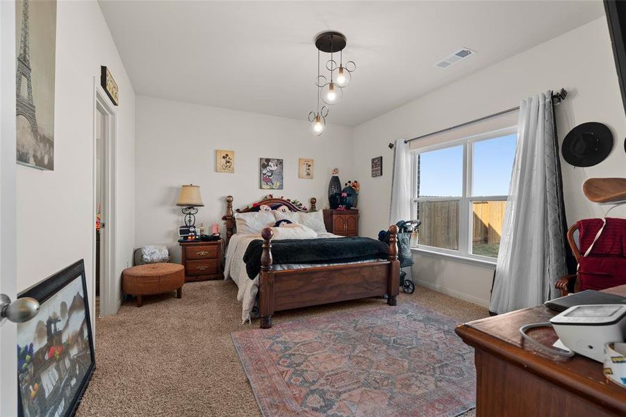 Bedroom featuring carpet floors and baseboards