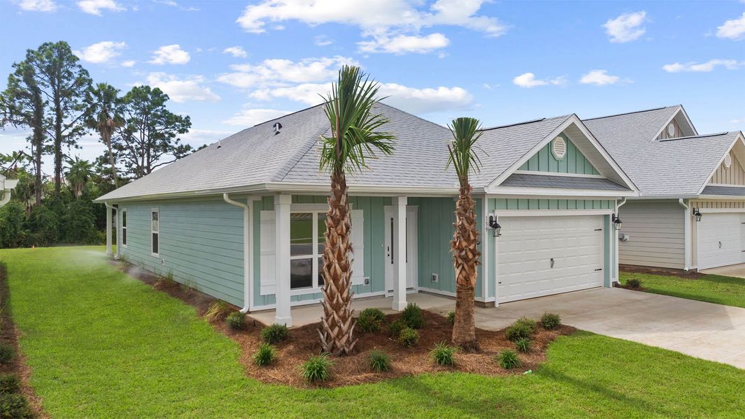 Front exterior of a new home in Caballeros Estates At Hombre, Panama City Beach, FL, highlighting curb appeal (Image 2).