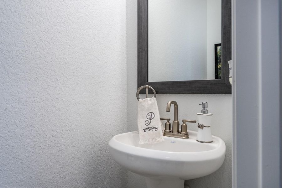 Half Bath convenient to back door that could easily be used as a pool bath.