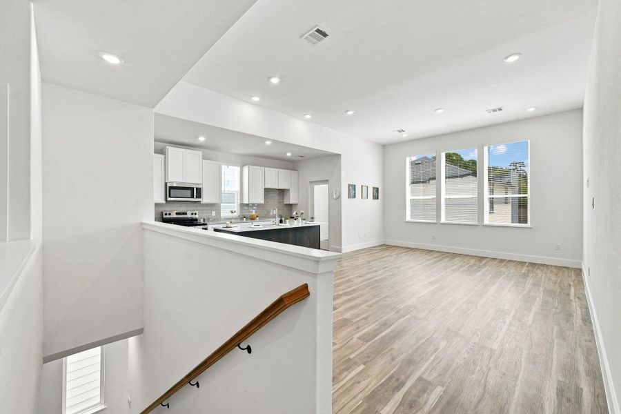Spacious open-concept living and kitchen area with high ceilings, abundant natural light, and plenty of room for entertaining. Spacious open-concept living and kitchen area with high ceilings, abundant natural light, and plenty of room for entertaining.