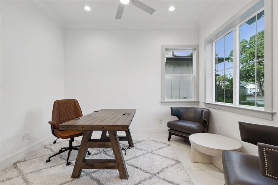 Office area featuring ceiling fan and crown molding