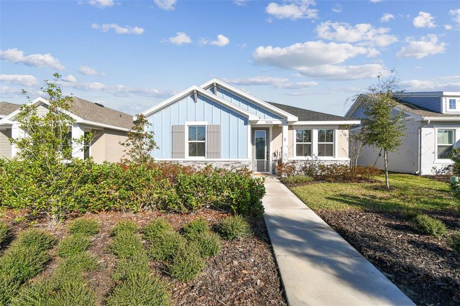 Front exterior of a new home in Persimmon Park - Cottage Series, Wesley Chapel, FL, highlighting curb appeal (Image 2). Front exterior of a new home in Persimmon Park - Cottage Series, Wesley Chapel, FL, highlighting curb appeal (Image 2).