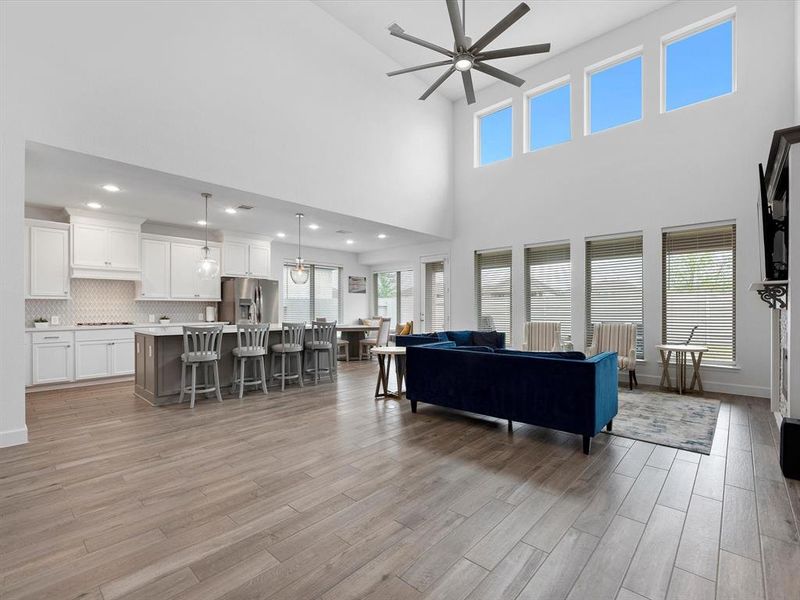 Soaring ceilings, natural light, and open concept flow in this haven of a living/kitchen space