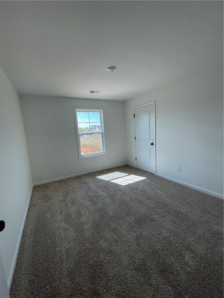 This cozy room offers soft carpet flooring and a b