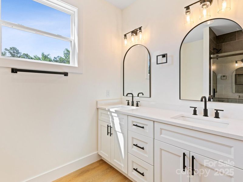 Duel sinks with quarts counters and black hardware make this not only functional but elegant.