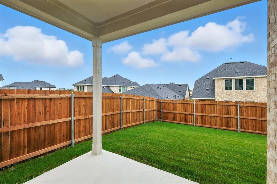 Fenced backyard with a patio and a residential view