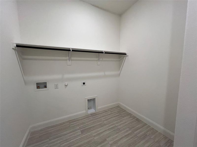 Laundry area with ceramic flooring and hookups for an electric dryer and a washing machine Laundry area with ceramic flooring and hookups for an electric dryer and a washing machine