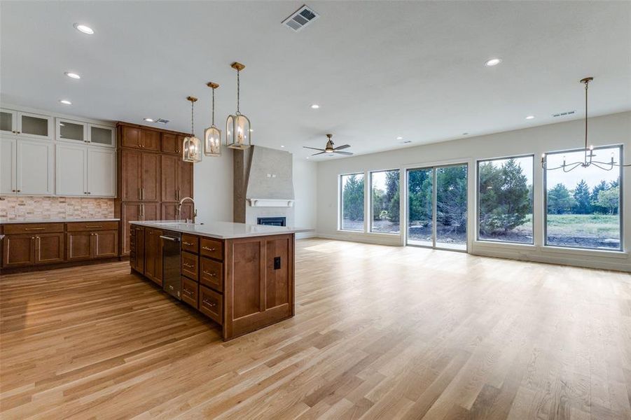 Kitchen with a chandelier, recessed lighting, light wood finished floors, backsplash, and a ceiling fan