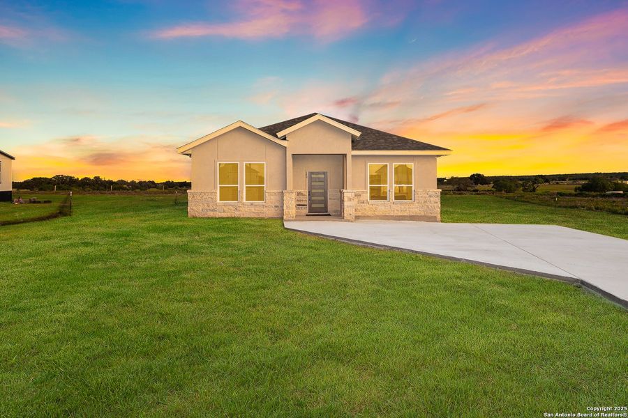 Front exterior of a new home in , La Vernia, TX, highlighting curb appeal (Image 23).
