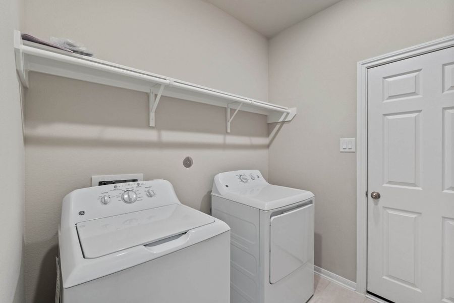 The laundry room layout is carefully planned for optimal workflow with designated areas for washing, drying, and storing.