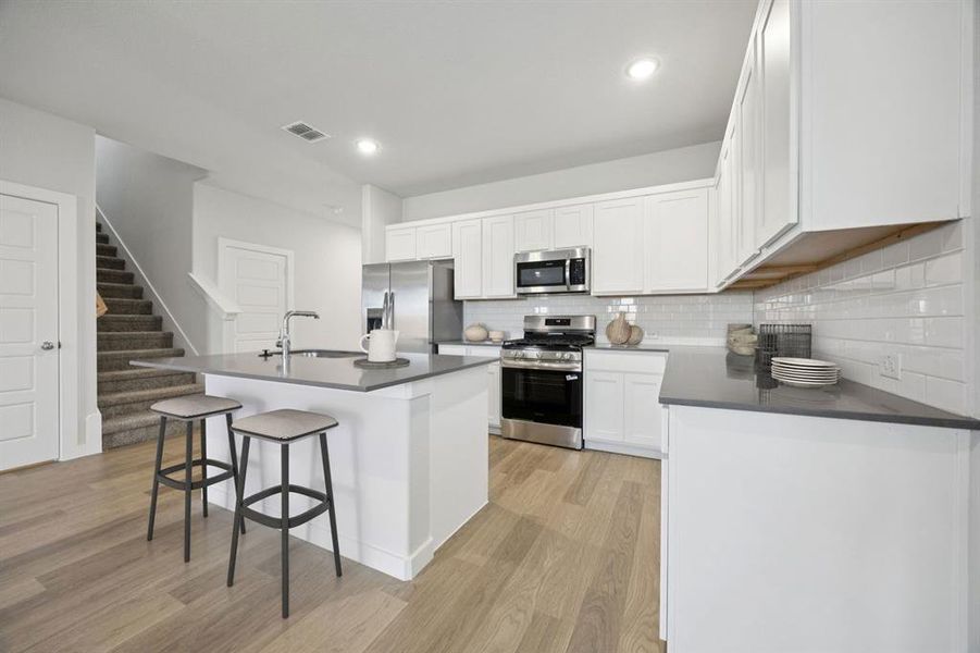 Kitchen in the Haylee home plan by Trophy Signature Homes - REPRESENTATIVE PHOTO