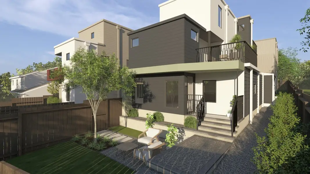 Rear view of house with stucco siding and a balcony