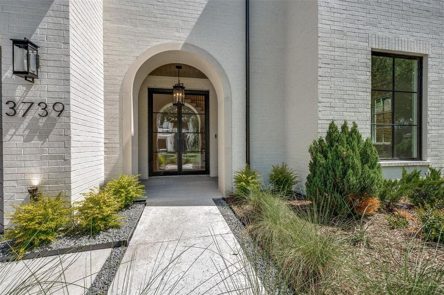 Doorway to property featuring brick siding Doorway to property featuring brick siding