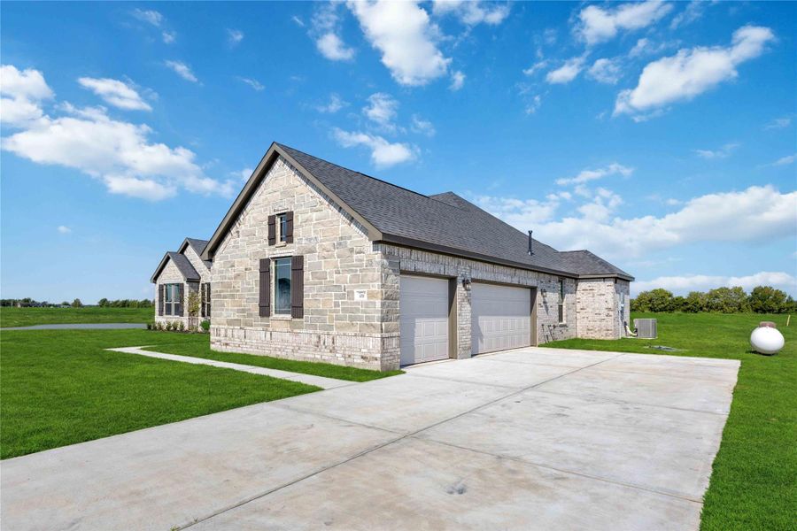 Front exterior of a new home in Blue Heron Estates, Beasley, TX, highlighting curb appeal (Image 1).