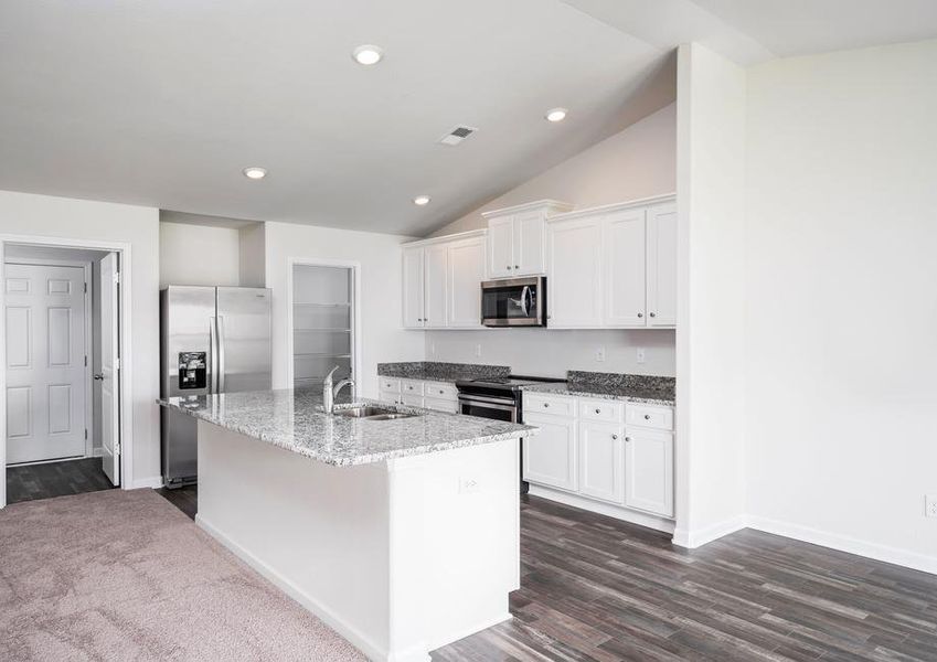 Chef-ready kitchen with oversized island, granite countertops and stainless steel appliances.