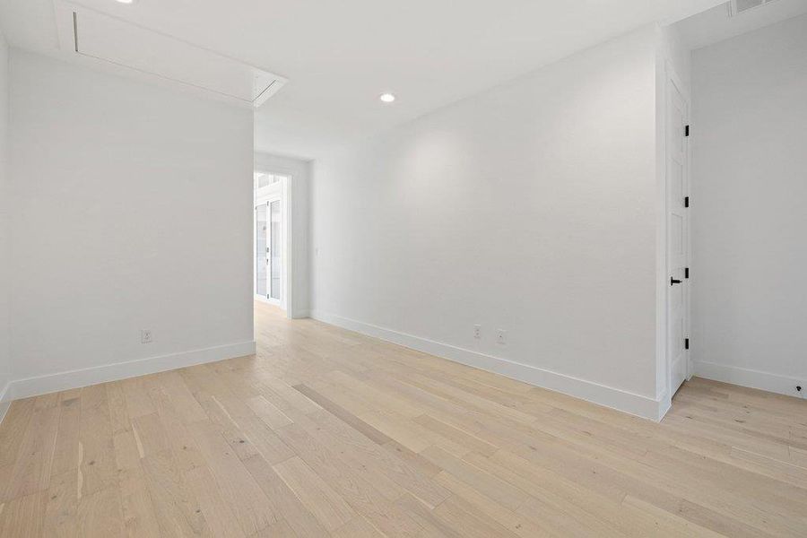 Unfurnished room with light wood-type flooring and recessed lighting