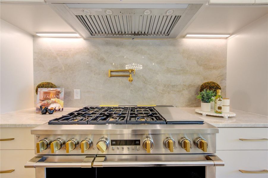 Warm wood tones, sophisticated textures, and striking pendant lighting create a kitchen as beautiful as it is functional.