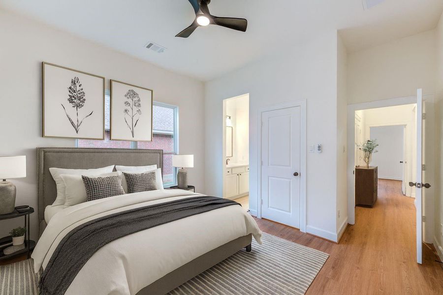 This inviting staged secondary bedroom features a cozy, modern design with warm wood flooring, tasteful decor, and an ensuite bathroom, offering a perfect retreat for relaxation. This inviting staged secondary bedroom features a cozy, modern design with warm wood flooring, tasteful decor, and an ensuite bathroom, offering a perfect retreat for relaxation.