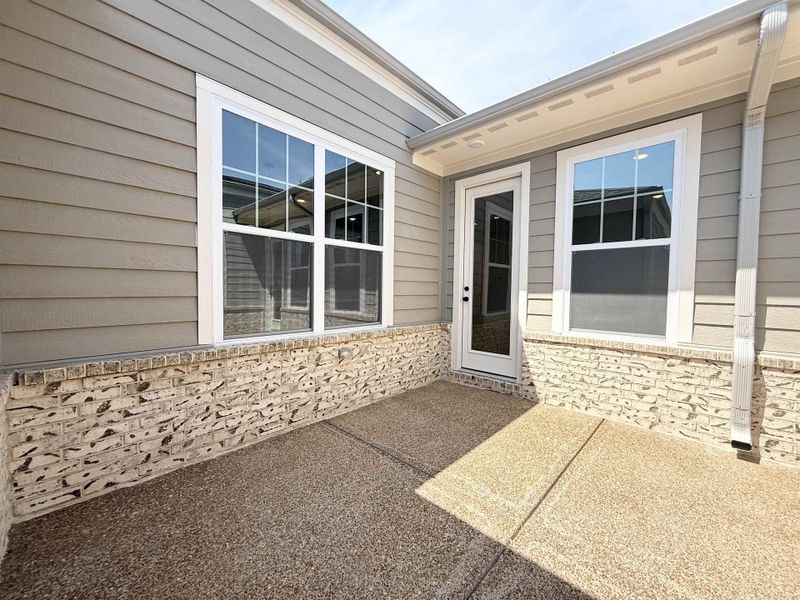 Doorway to property with a patio area