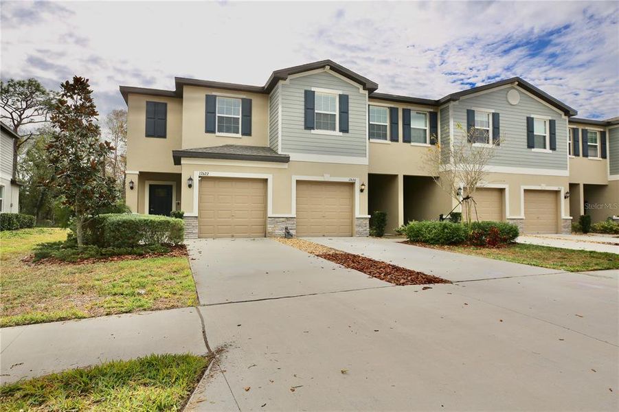 Front exterior of a new home in , Land O' Lakes, FL, highlighting curb appeal (Image 2).