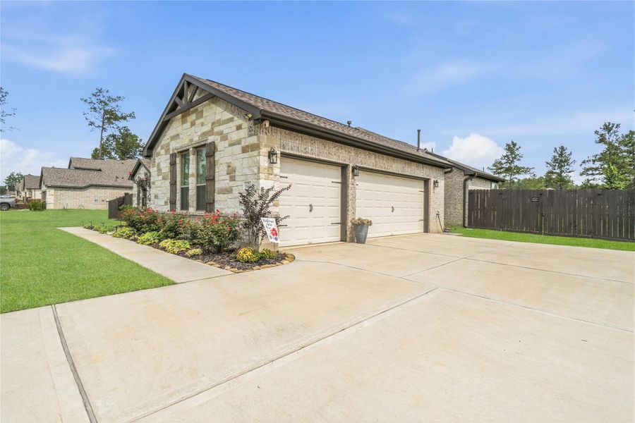 A spacious three-car garage and extended driveway provide both convenience and functionality, ideal for extra vehicles, storage, or hobbies.