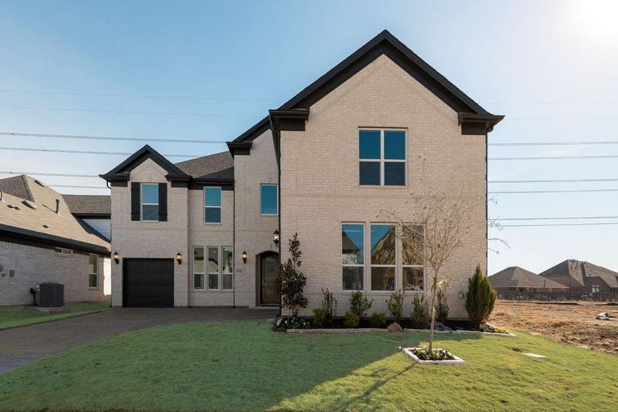 Front exterior of a new home in Cedar Ridge Estates, Grand Prairie, TX, highlighting curb appeal (Image 2). Front exterior of a new home in Cedar Ridge Estates, Grand Prairie, TX, highlighting curb appeal (Image 2).