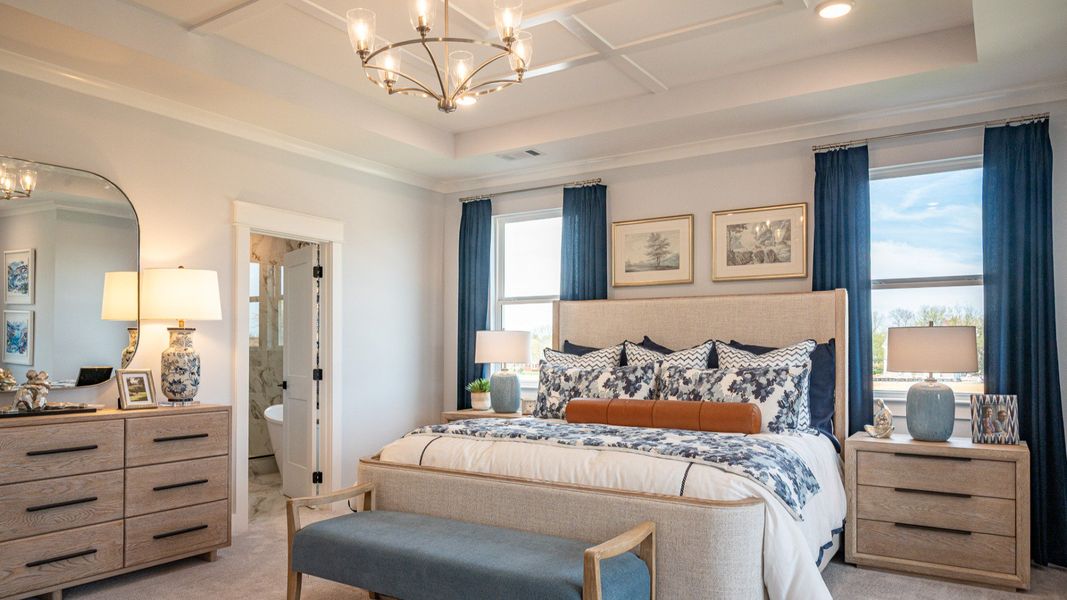 Oversized bedroom with accent trim tray ceiling, and king-sized bed