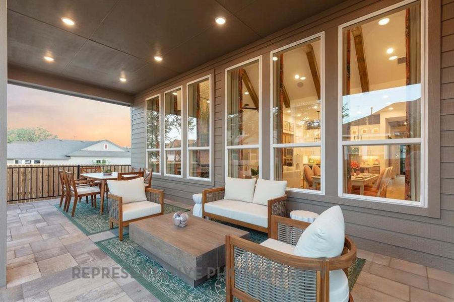 Patio terrace at dusk with an outdoor hangout area, outdoor dining space, and a patio