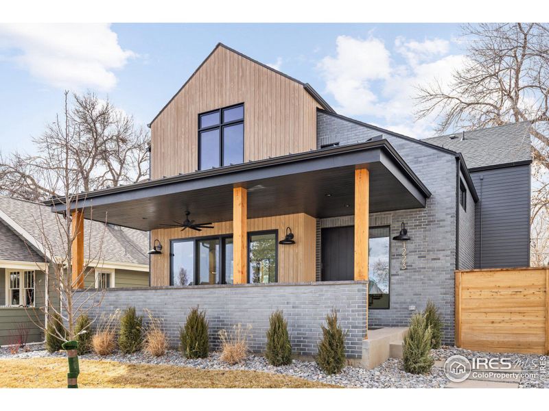 Beautiful covered front porch with sliding french doors from living room.