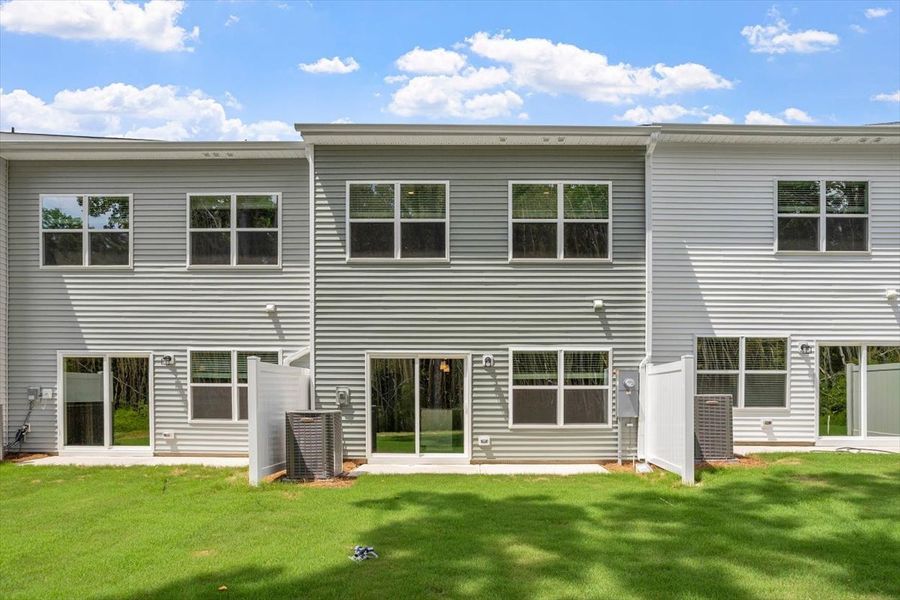 Exterior details and patio area of a home in West Main Townhomes, Sanford (Image 4).