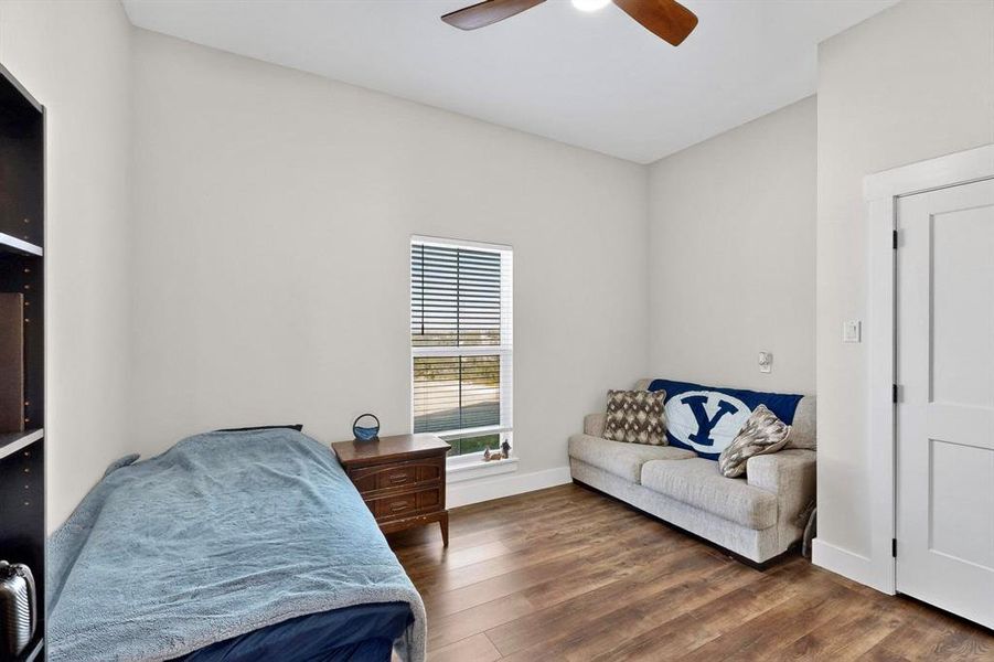 Bedroom with dark wood finished floors and a ceiling fan