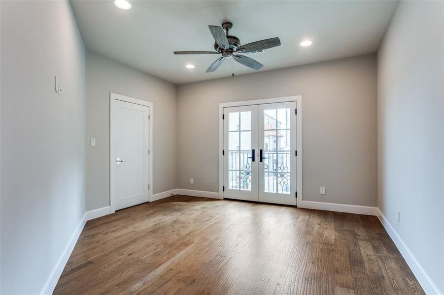 Spare room featuring wood-type flooring, french doors, and ceiling fan