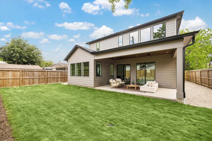 Enjoy the spacious backyard with lush zoysia grass, French drains, and holly bushes along the fence. The perfect place for your loved ones to run and play!