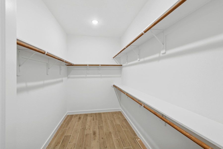 Walk-in closet in the primary suite (*Photo not of actual home and used for illustration purposes only.)