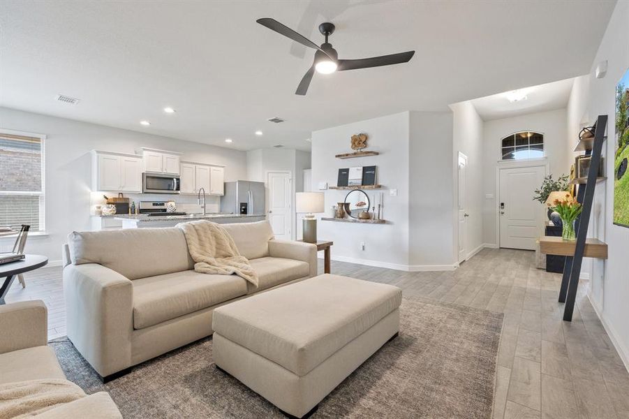 Living room with light wood-type flooring, baseboards, a ceiling fan, and recessed lighting Living room with light wood-type flooring, baseboards, a ceiling fan, and recessed lighting