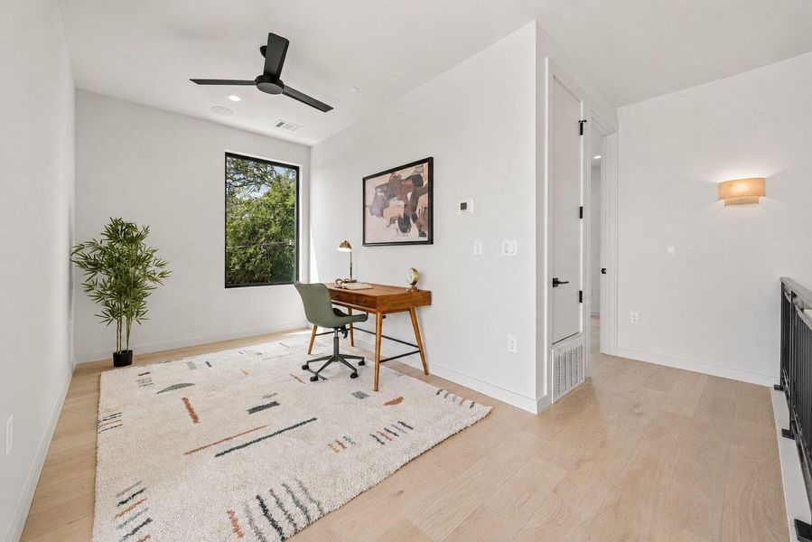 A well-lit room with ample natural light features a large window and hardwood flooring. A well-lit room with ample natural light features a large window and hardwood flooring.