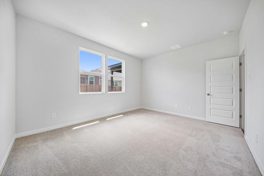A quiet bedroom with plush carpeting and abundant natural light through generous windows. A quiet bedroom with plush carpeting and abundant natural light through generous windows.