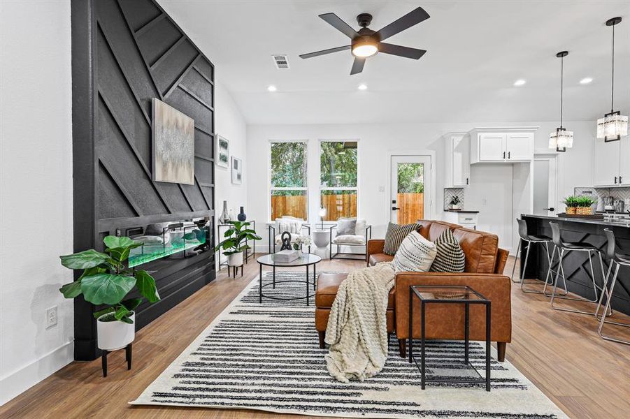 Living room with ceiling fan and light wood-type flooring