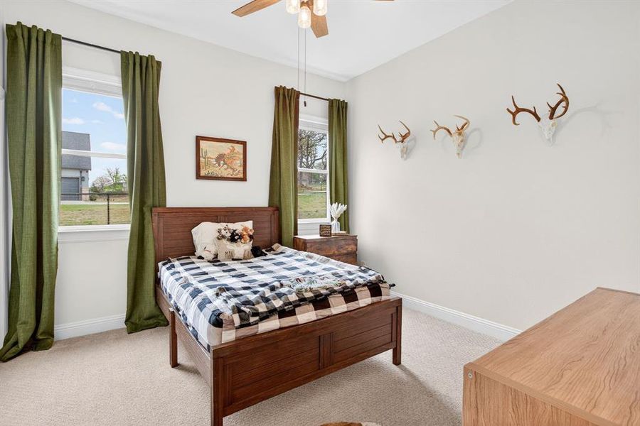 Bedroom with light colored carpet and ceiling fan Bedroom with light colored carpet and ceiling fan