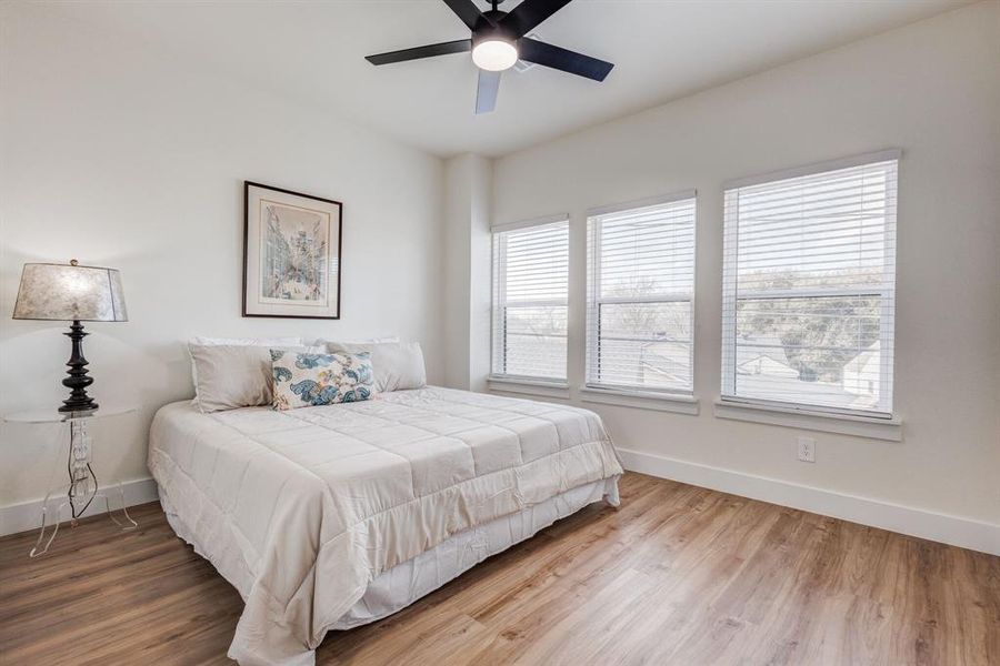 Bedroom with hardwood / wood-style floors and ceiling fan Bedroom with hardwood / wood-style floors and ceiling fan