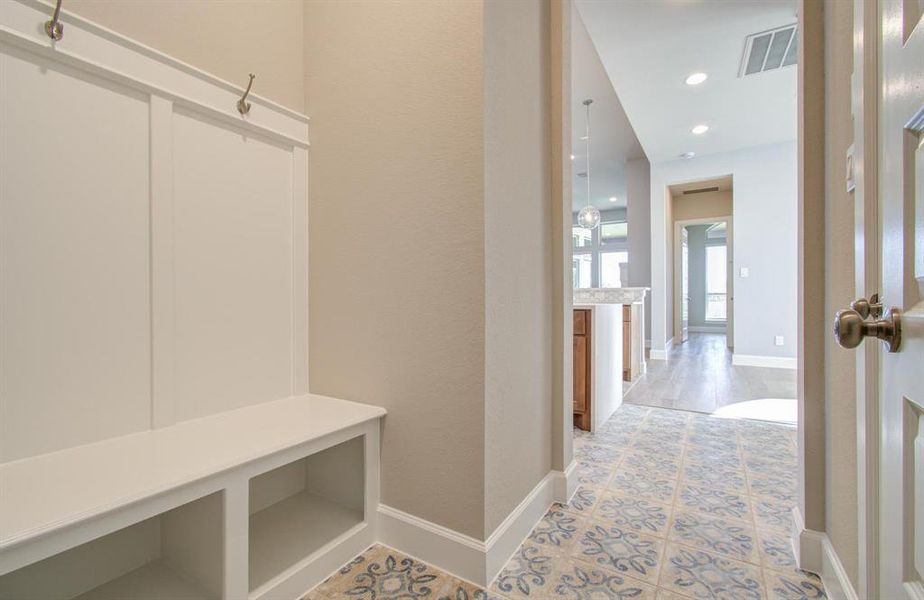 Mudroom with upgraded flooring.