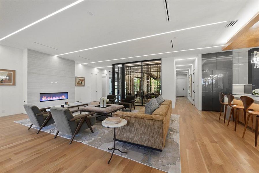 Open-concept living space with light wood-finish flooring