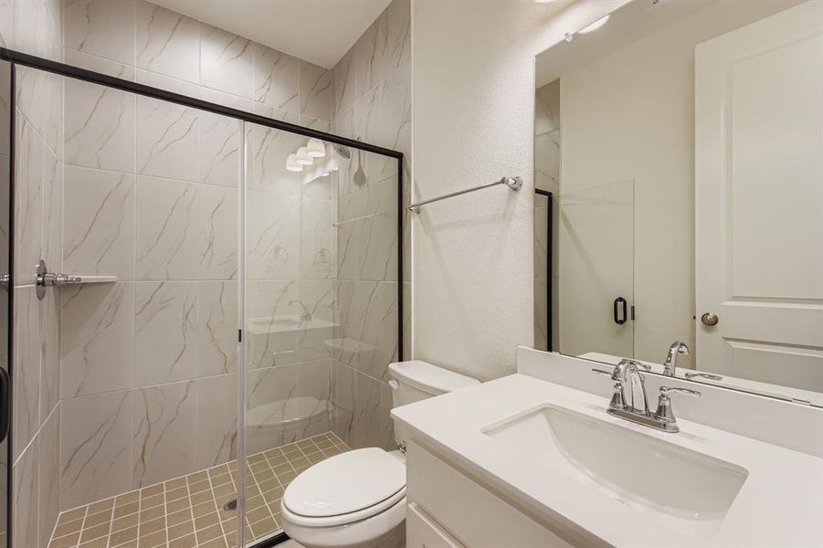 Full bath with vanity and a marble finish shower Full bath with vanity and a marble finish shower