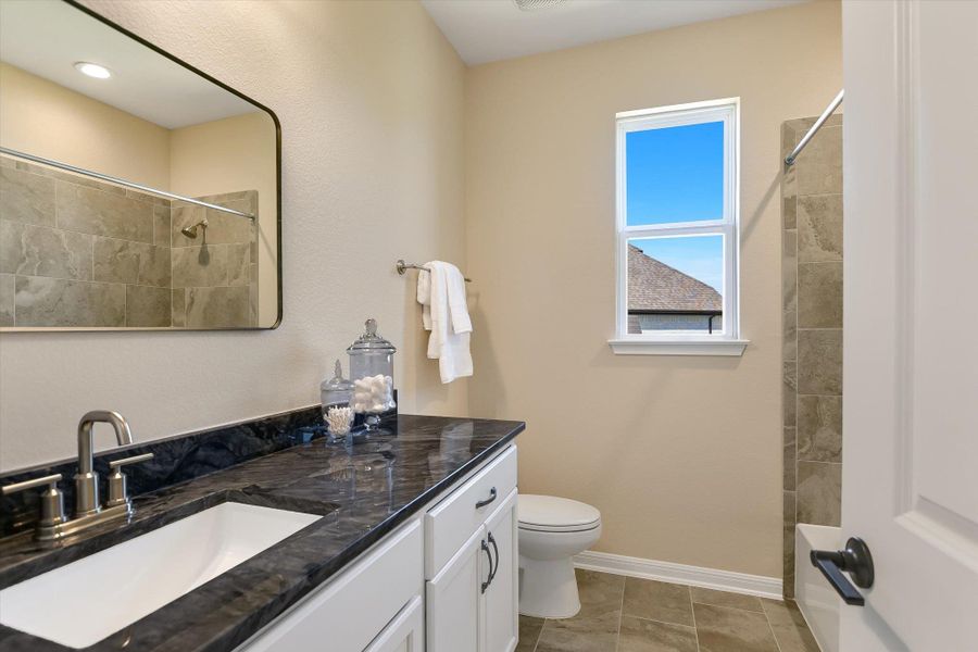 This spacious hall bathroom is shared by bedroom 2 and 3.