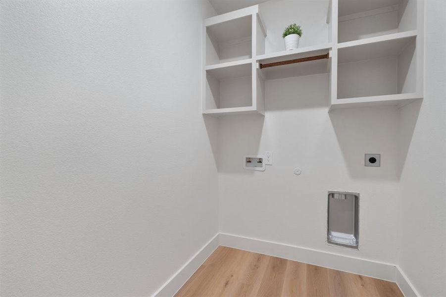 Laundry area featuring hookup for a gas dryer, light wood-style floors, hookup for a washing machine, and hookup for an electric dryer